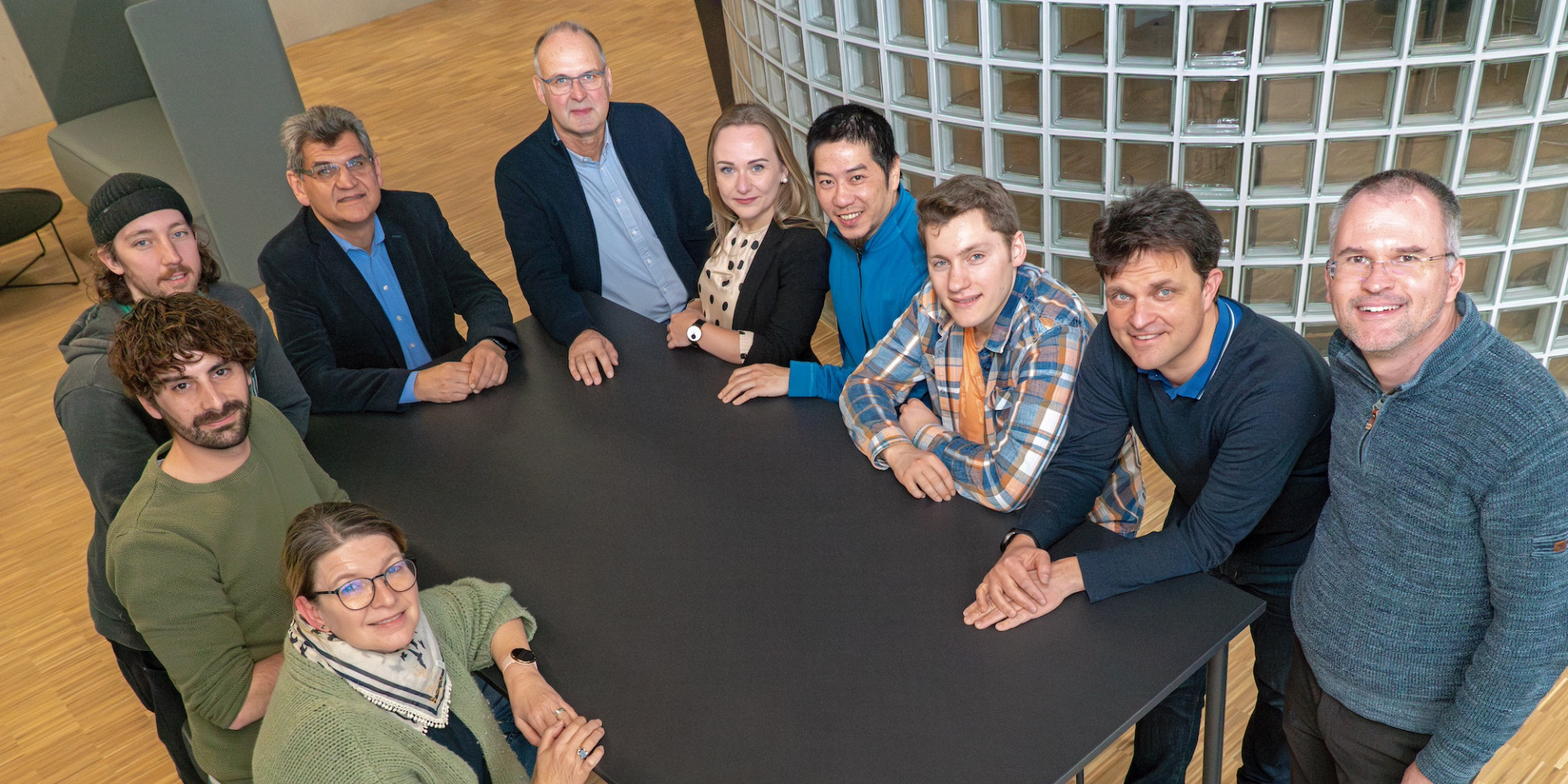 Gruppenbild mit 10 Personen rund um einen Tisch